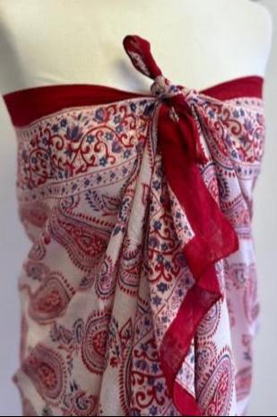 A striking red and white block printed sarong. Measuring 1m 80 x 1m, this handmade sarong features a vibrant block printed motif and makes a stunning cover up on the beach. It does so much more however and is a 'must pack' summer piece. I never go away to the sun without at least three! They are simply so versatile, making wonderful wrap skirts, scarves, tops, beach dresses and head wraps. In short, this beautiful sarong is a real multi-tasker and you can go super chic or super cool in how you style