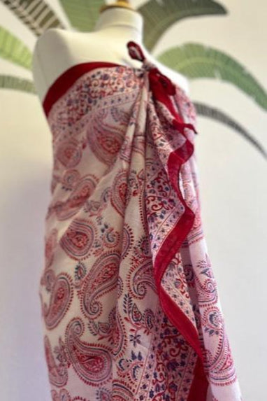 A striking red and white block printed sarong. Measuring 1m 80 x 1m, this handmade sarong features a vibrant block printed motif and makes a stunning cover up on the beach. It does so much more however and is a 'must pack' summer piece. I never go away to the sun without at least three! They are simply so versatile, making wonderful wrap skirts, scarves, tops, beach dresses and head wraps. In short, this beautiful sarong is a real multi-tasker and you can go super chic or super cool in how you style
