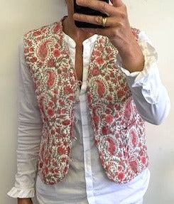 reversible cotton quilted gilet, padded waistcoat, pink and white floral print and coordinating print inside. pockets