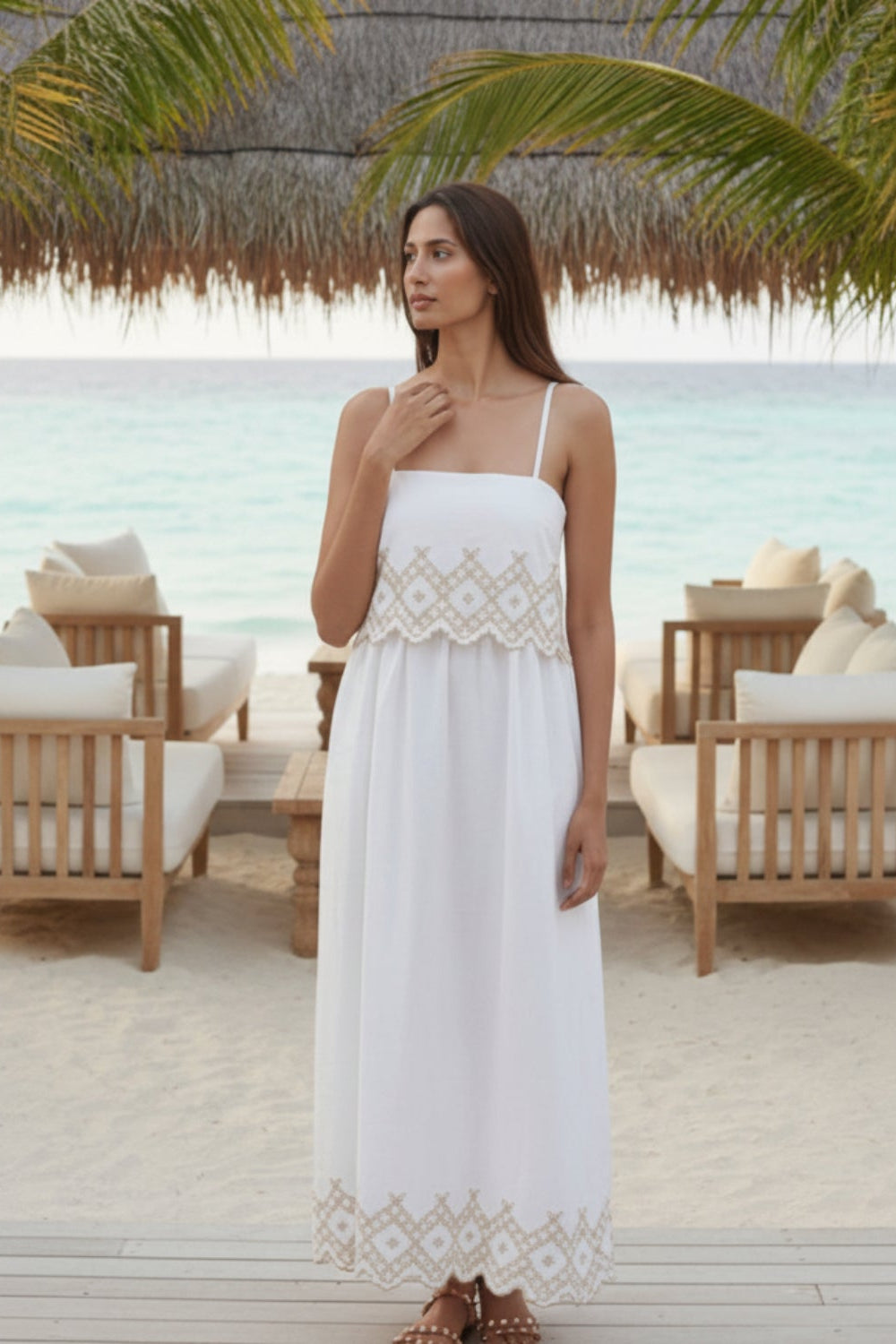 woman in white cotton maxi summer dress in a beach club in the maldives
