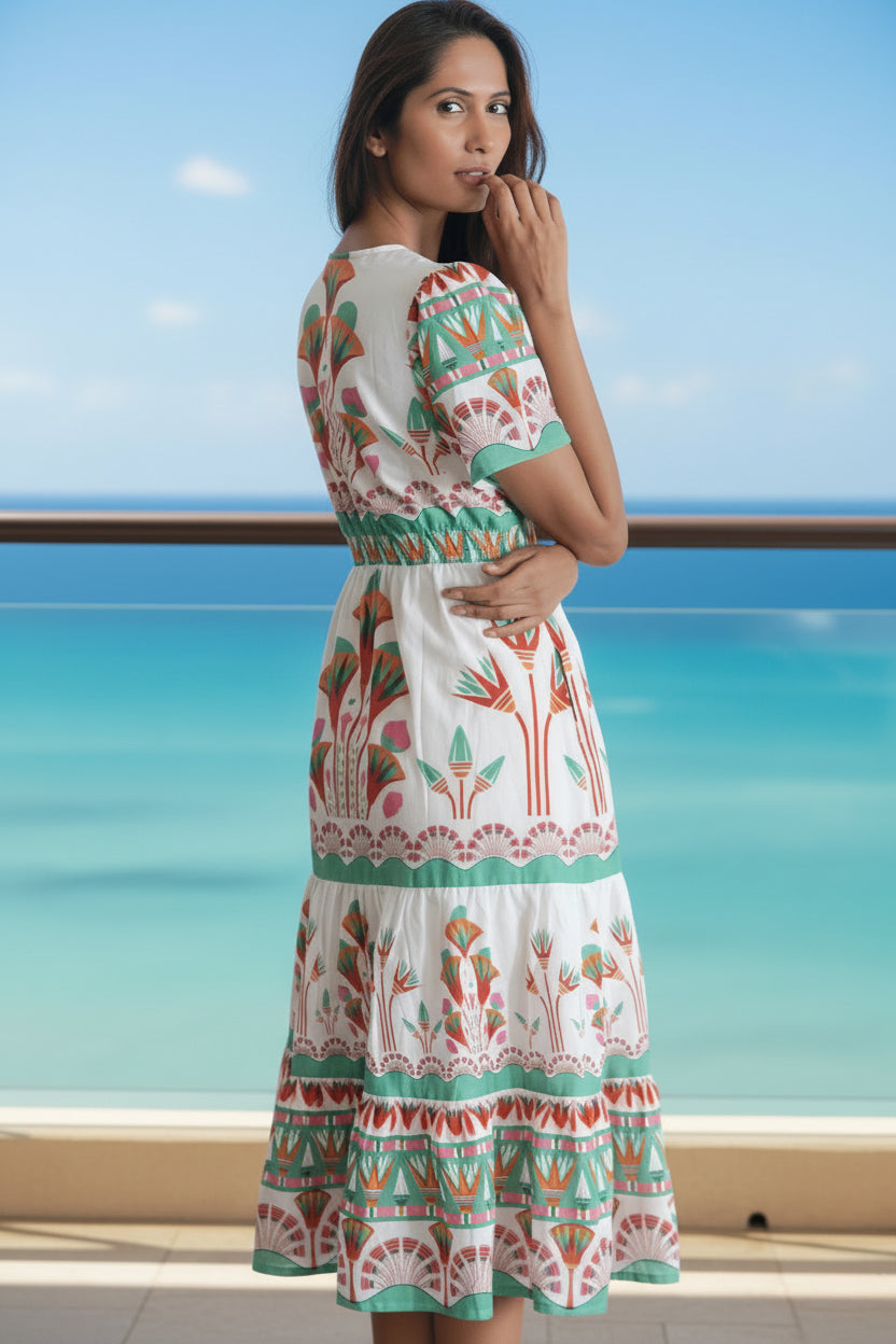 Woman wearing a colorful patterned dress on a white background