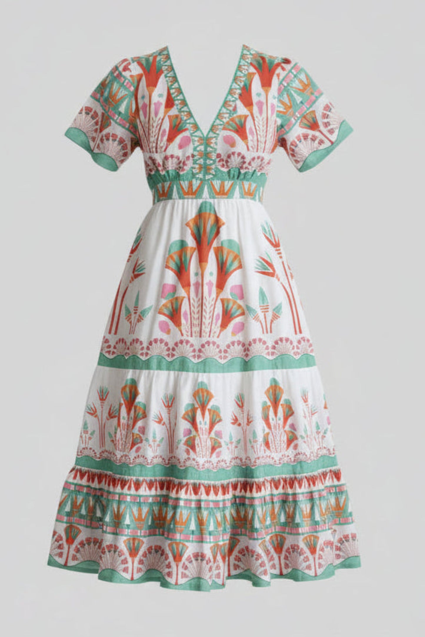 Woman wearing a colorful patterned dress against a plain background