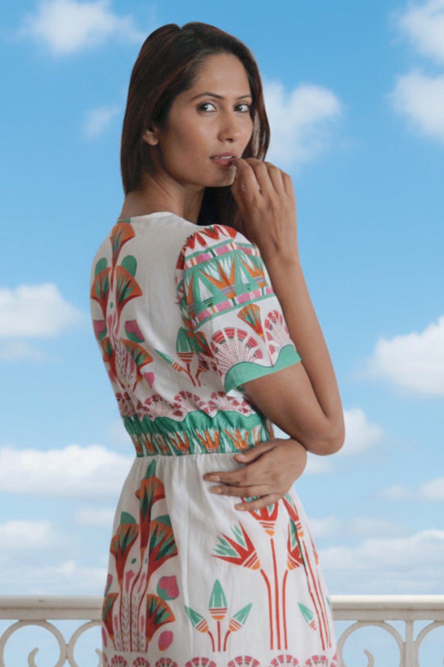 Woman wearing a colorful dress with a white background